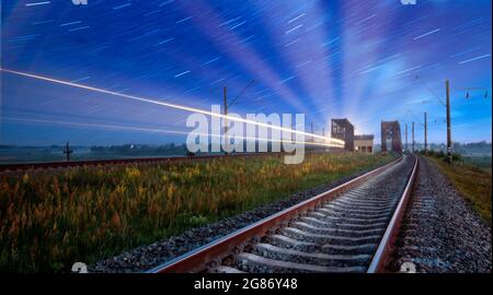 The passenger train was shot at dawn at long exposure. Stock Photo