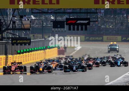 Silverstone Circuit, Silverstone, Northamptonshire, UK. 17th July, 2021. Formula One British Grand Prix, Sprint Race; Red Bull Racing Honda driver Max Verstappen leads into the first corner Credit: Action Plus Sports/Alamy Live News Stock Photo