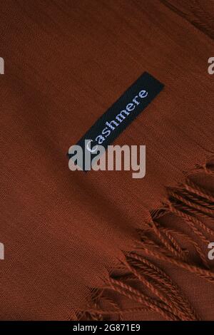 Deep brown cashmere texture. Chocolate textile background. Fabric label on coffee cashmere scarf. Material information. Top view. Comfortable style Stock Photo