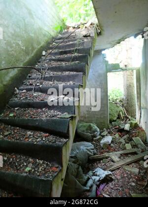 The damaged staircase in an abandoned building. Stairway to an non existing upper floor. Stock Photo