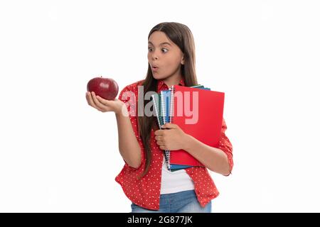 surprised girl with notebook. back to school. child with apple ready to study. healthy childhood. Stock Photo