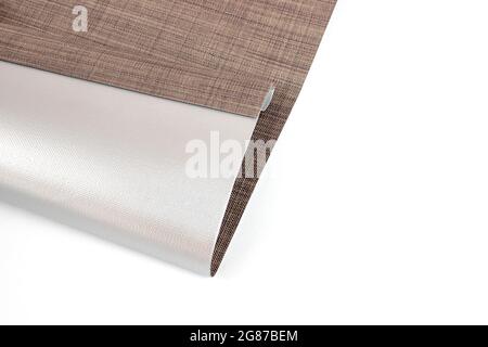 Sun and Heat Protection. Roller blinds are made from texture material. Close up roman blind or roller blind linen fabric texture sample. Stock Photo
