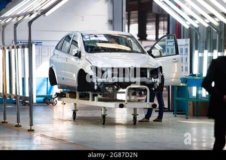 Kostanay,Kazakhstan,May14,2012:Saryarkaavtoprom auto-building plant. Ssangyong cars assembling. Quality control of car body painting. Close-up p Stock Photo