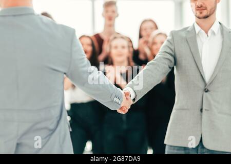 close up. young people confidently shaking hands . photo with copy space Stock Photo