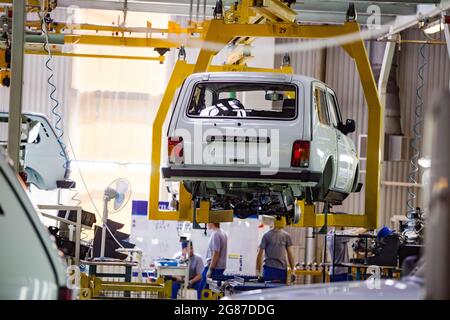Ust'-Kamenogorsk, Kazakhstan - May 31,2012: Asia-Auto company auto-building plant conveyor line. Lada VAZ car bodies suspended on bracket. Stock Photo