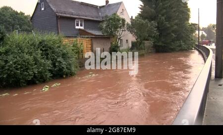 Oberlungwitz, Germany. 17th July, 2021. A flooded road. Extreme rainfall has led to flooding. Credit: André März/dpa/Alamy Live News Stock Photo