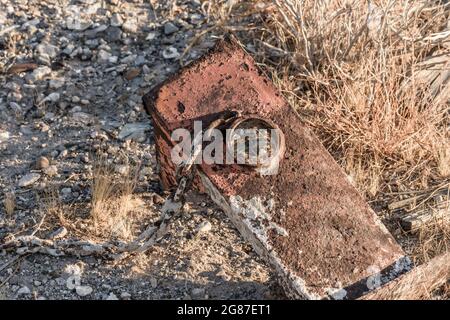 Steel Bracket with cement covered chain sitting in the Arizona desert. Stock Photo