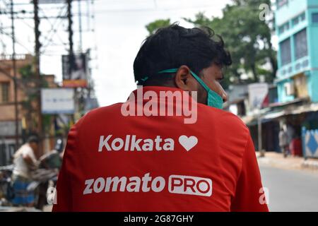 Kolkata, India. 17th July, 2021. A delivery worker of Zomato, an Indian food-delivery start-up, rides his bicycle along a road in Kolkata, (Photo by Sudipta Das/Pacific Press) Credit: Pacific Press Media Production Corp./Alamy Live News Stock Photo