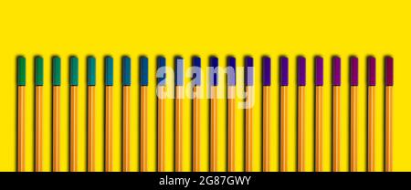 Colorful pens organised on a yellow background, lined up straight. back to school concept Stock Photo