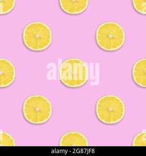 Lemon seamless pattern on a pink background. Tropical fruit seamless texture. Summer background. Top view, flat lay. Stock Photo