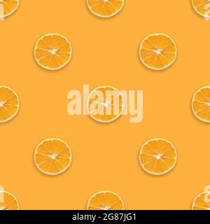 Seamless pattern with orange fruit on orange background. Orange slices seamless texture for the design. Summer background. Fruit pattern. Stock Photo