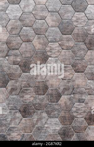 Hexagonal tile wall, gray hexagonal tile, outdoor wall, space for text. Vertical Stock Photo