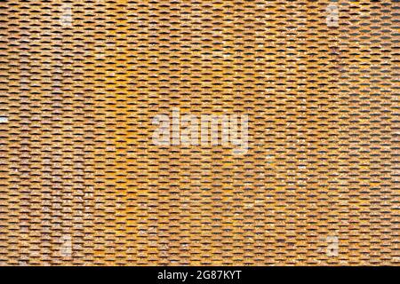 Rusty metal mesh texture. Copy space. Yellow color. Stock Photo