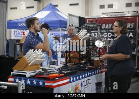Houma, USA. 17th July, 2021. A woman talks to an exhibitor during the annual Bayou Home Show and Cannata's Festival of Food in Houma, Louisiana, the United States, on July 17, 2021. The home show and festival of food is held on Saturday and Sunday in Houma, showcasing the latest products and services in kitchens, bathrooms, siding and solar products. Credit: Lan Wei/Xinhua/Alamy Live News Stock Photo