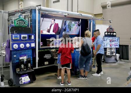 Houma, USA. 17th July, 2021. Visitors try a new product during the annual Bayou Home Show and Cannata's Festival of Food in Houma, Louisiana, the United States, on July 17, 2021. The home show and festival of food is held on Saturday and Sunday in Houma, showcasing the latest products and services in kitchens, bathrooms, siding and solar products. Credit: Lan Wei/Xinhua/Alamy Live News Stock Photo