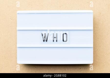 White lightbox with word who on wood background Stock Photo