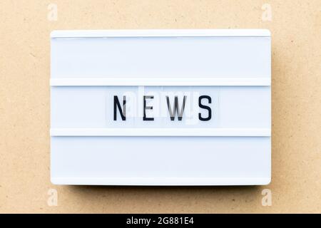White lightbox with word news on wood background Stock Photo