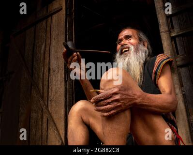 Portrait of an old Sedang man (ethnic minority in Kontum, Central Vietnam). With a cheerful smile, and carefree, he made a good impression on me about the Stock Photo