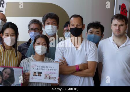 Tokyo, Japan. 17th July, 2021. Day seven of Frenchman, Vincent Fichot's (Centre with black mask) hunger strike outside Sendagaya Station.Vincent Fichot has not seen his two children since they were abducted by his wife in 2018. He started a hunger strike to put pressure on French President, Emmanuel Macron, who will be attending the 2020 Tokyo Olympic opening ceremony, to raise the issue further with the Japanese government. (Photo by Damon Coulter/SOPA Images/Sipa USA) Credit: Sipa USA/Alamy Live News Stock Photo