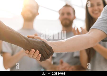 close up. handshake of two students on the background of the st Stock Photo