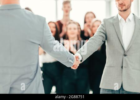 close up. young people confidently shaking hands Stock Photo