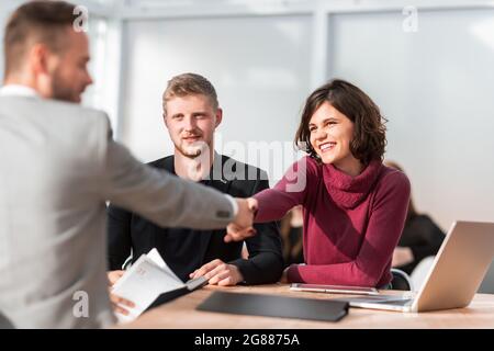 HR Manager shaking hands with young job seeker Stock Photo