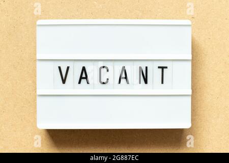 Lightbox with word vacant on wood background Stock Photo