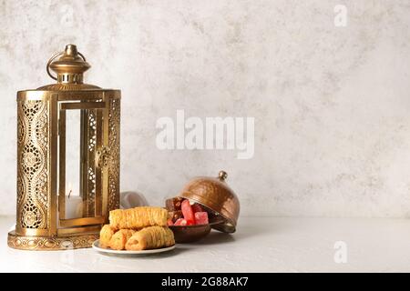 Muslim lantern with Turkish sweets on light background Stock Photo
