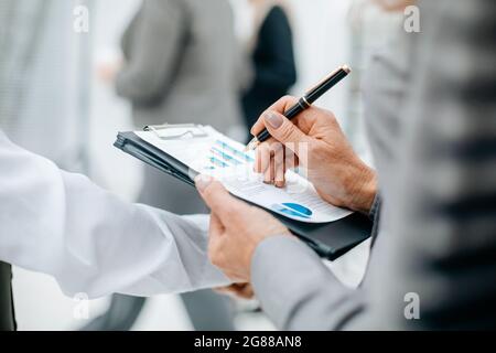 close up. businesswoman checking financial document. business concept Stock Photo