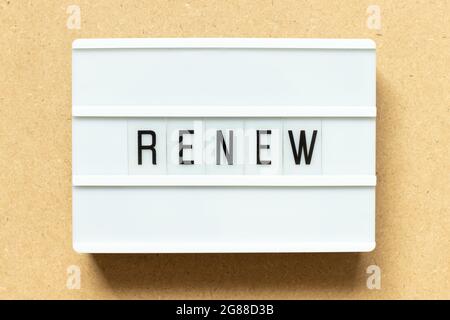 Lightbox with word renew on wood background Stock Photo