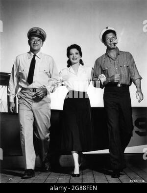JOHN WAYNE as Frank Wead MAUREEN O'HARA as Min Wead and DAN DAILEY publicity portrait for THE WINGS OF EAGLES 1957 director JOHN FORD screenplay Frank Fenton and William Wister Haines based on the life and writings of Frank W. ''Spig'' Wead Metro Goldwyn Mayer Stock Photo