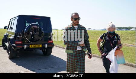 Mercedes' Lewis Hamilton and performance coach Angela Cullen arriving at the paddock before the British Grand Prix at Silverstone, Towcester. Picture Date: Sunday July 18, 2021. Stock Photo