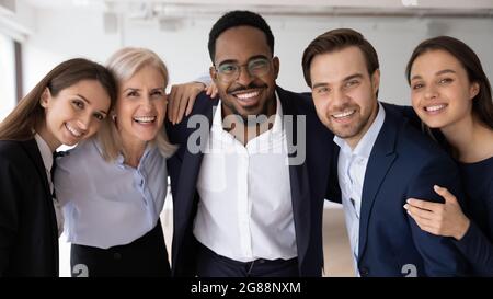 Happy multiethnic different aged business group celebrating corporate success Stock Photo