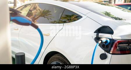 Electric Car parked at electric charging station Stock Photo
