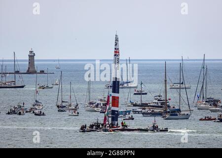 Team Great Britain boarding their catamaran for the SailGP races in Plymouth Sound July 2021. They are surrounded by spectators in small boats. Stock Photo