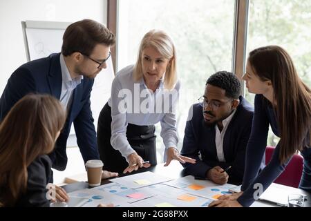 Mature business teacher training group of employees Stock Photo