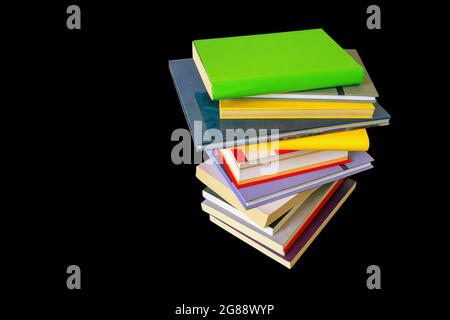 Stack of colorful  books isolated on black background Stock Photo