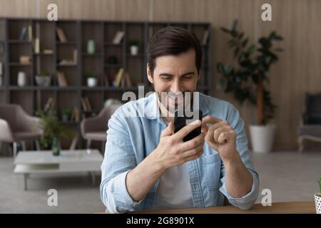 Happy young man using modern technology gadget. Stock Photo