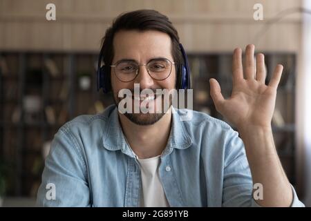 Sincere smiling young businessman holding video call conversation. Stock Photo