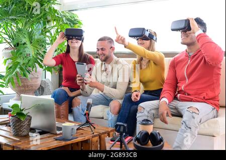 Young people employee workers having fun with vr wearing augmented reality headsets in startup office - High tech office professional people use virtu Stock Photo