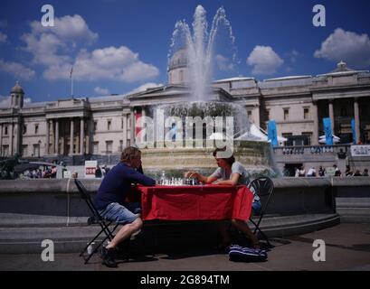People play chess in Trafalgar Square, London as part of ChessFest, organised by Chess in Schools and Communities (CSC), a charity that uses chess to help children's educational and social development. Picture date: Sunday July 18, 2021. Stock Photo