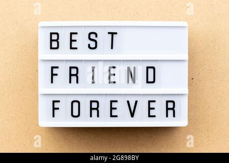Light box with word best friend forever on wood background Stock Photo