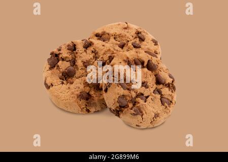 Cookies with chocolate and nuts, three biscuits isolated on Brown background Stock Photo