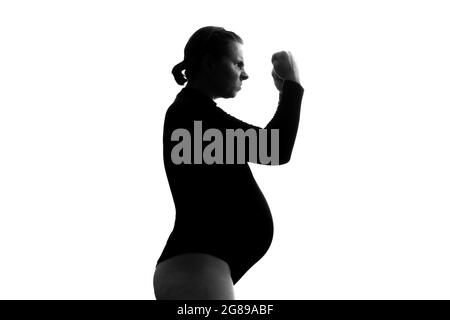 Screaming angry young pregnant woman. Silhouette view Stock Photo