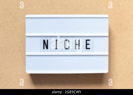 White lightbox with word niche on wood background Stock Photo