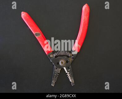 A Pair of Wire Strippers on a Black Background Stock Photo