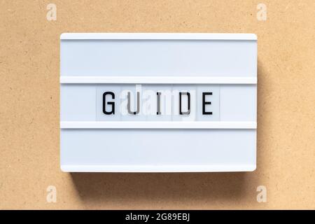 White lightbox with word guide on wood background Stock Photo