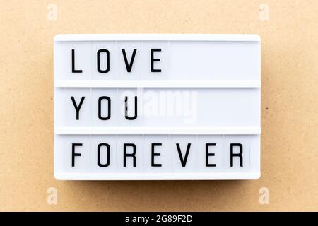 Light box with word love you forever on wood background Stock Photo