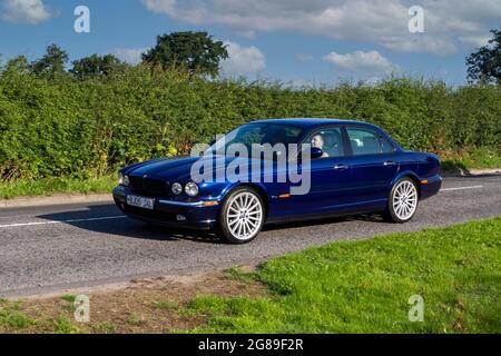 2005 blue Jaguar V8 sport 6 speed automatic 3555 cc 4dr vehicle en-route to Capesthorne Hall classic July car show, Cheshire, UK Stock Photo