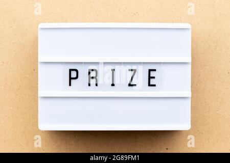 Light box with word prize on wood background Stock Photo